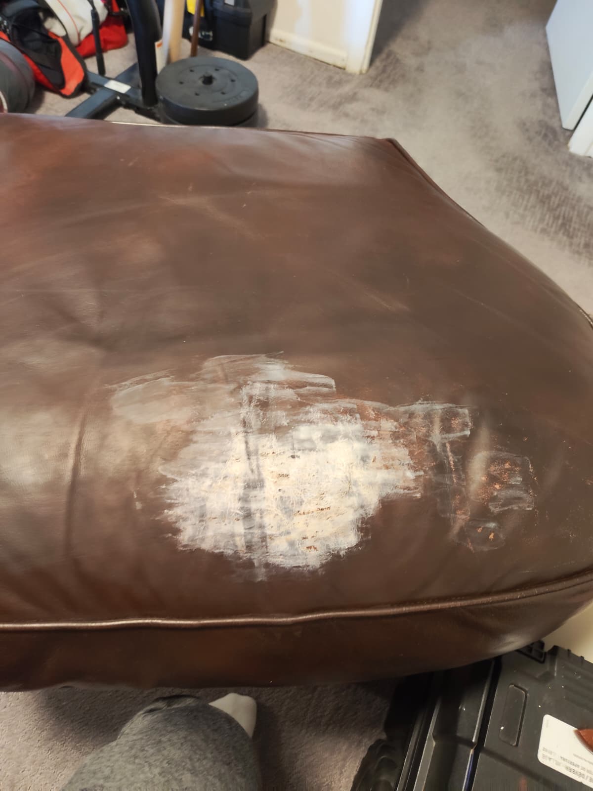 Damaged leather couch before restoration
